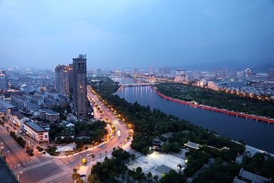 High angle view of illuminated city buildings against sky