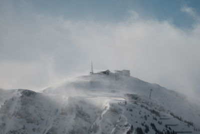 Scenic view of snow covered mountains against sky