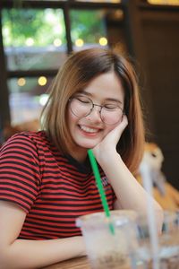 Portrait of a smiling girl sitting on table