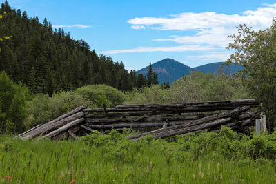 Scenic view of land and mountains against sky