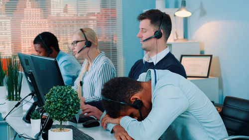 Side view of business colleagues working in office