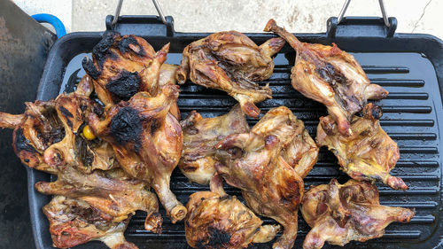 High angle view of meat on barbecue grill