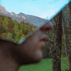 Close-up of man with mirror at park