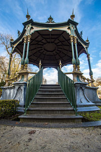 Low angle view of staircase by building against sky