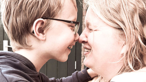 Side view of smiling mother and son