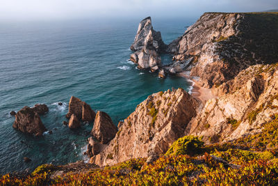 High angle view of rocks on sea shore