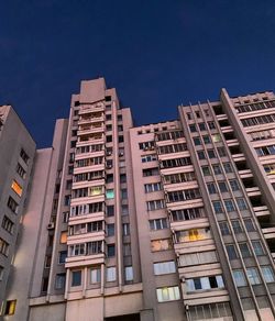 Low angle view of modern buildings against blue sky