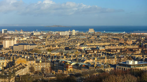 High angle view of townscape by sea against sky