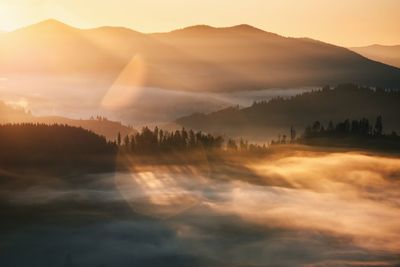 Scenic view of silhouette mountains against sky during sunset