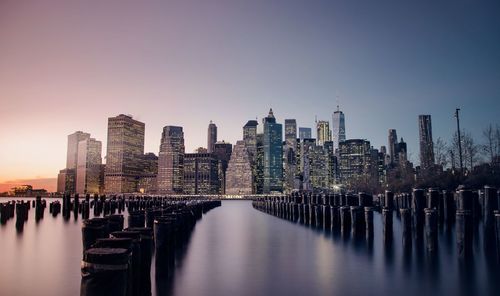 City at waterfront against clear sky