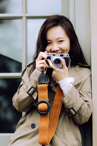 Young woman photographing with camera