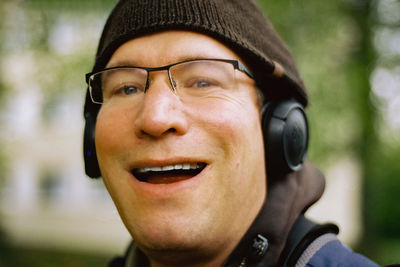 Close-up portrait of man wearing cap and headphones