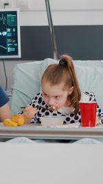 Portrait of cute girl playing with toys on table