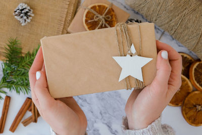 Cropped hand of woman holding gift box