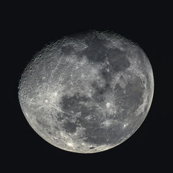 Low angle view of moon against dark sky