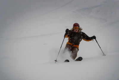 Man skiing on snow covered mountain