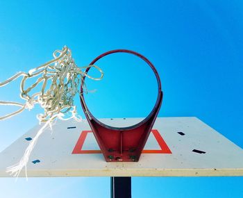 Low angle view of basketball hoop against blue sky