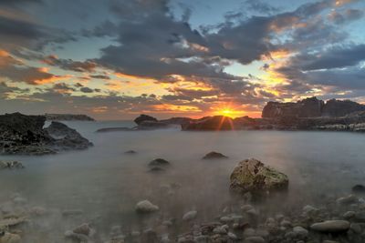 Scenic view of sea against sky at sunset