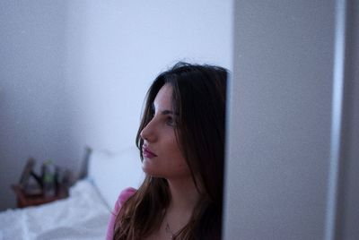 Thoughtful young woman at home