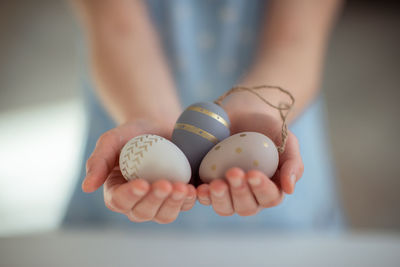 Cropped hand of woman holding easter eggs