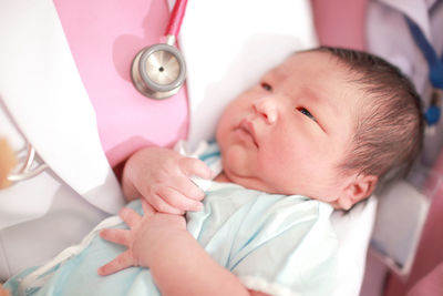 Midsection of doctor carrying newborn baby girl