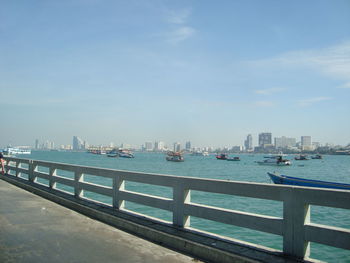 Cityscape by sea against sky