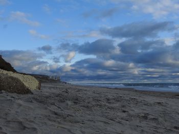 Scenic view of beach against sky during sunset