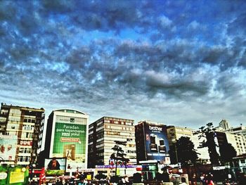 Buildings against cloudy sky