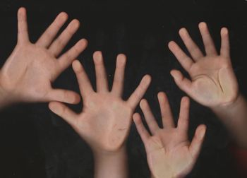 Close-up of human hand against black background