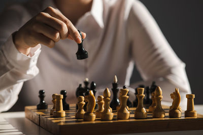 Midsection of man playing chess