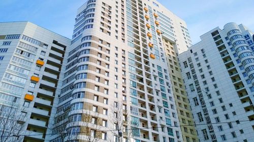 Low angle view of modern buildings in city against sky