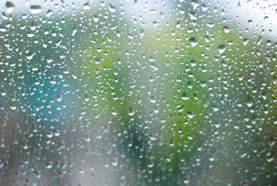 Full frame shot of wet glass window during rainy season