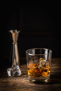 Close-up of drink on table against black background