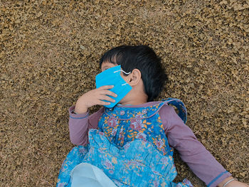 High angle view of woman drinking water from land
