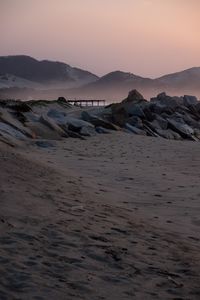 Scenic view of beach against sky during sunset