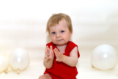 Portrait of cute girl playing with balloons