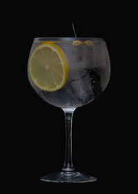 Close-up of beer glass against black background