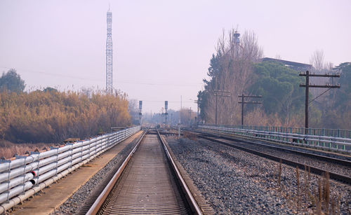 View of two parallel tracks on the railway near a station