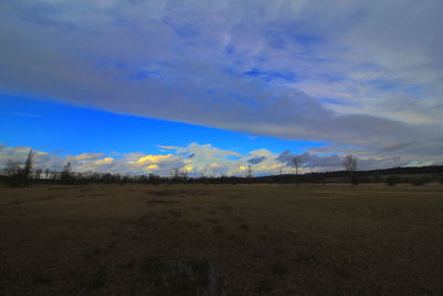 Scenic view of field against blue sky