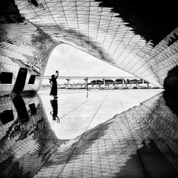 Rear view of man jumping in city