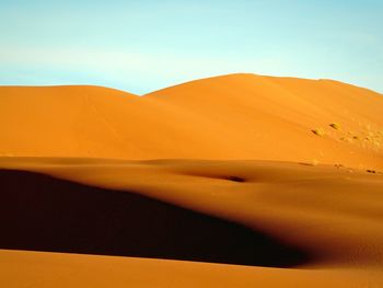 Scenic view of desert against clear sky