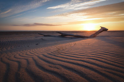 Scenic view of beach against sky during sunset