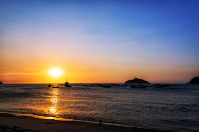 Scenic view of sea against clear sky at sunset