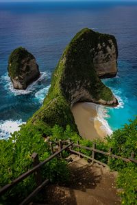 High angle view of rocks by sea against sky