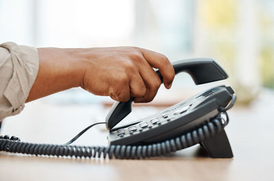 Midsection of man using mobile phone