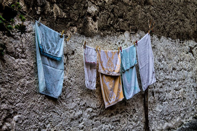 Close-up of clothes drying against the wall