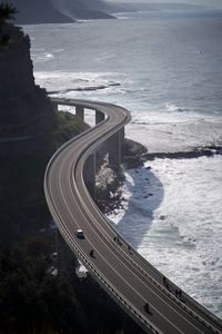 High angle view of highway by sea against sky