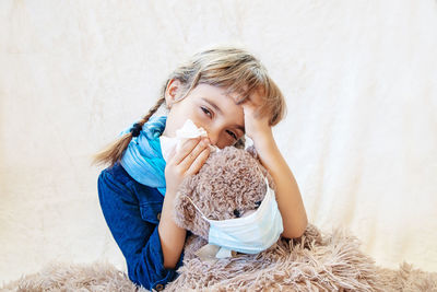 Sick girl covering mouth with tissue