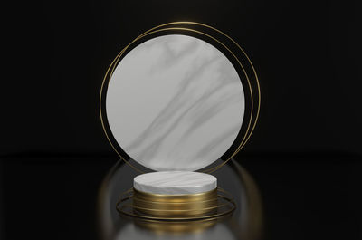 Close-up of glass table against black background