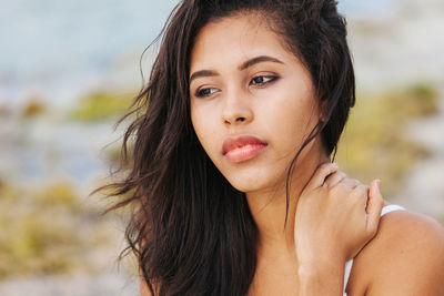 Close-up portrait of beautiful woman against sky